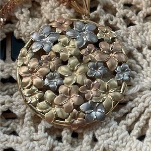 14K gold necklace with flowers on the pendant.